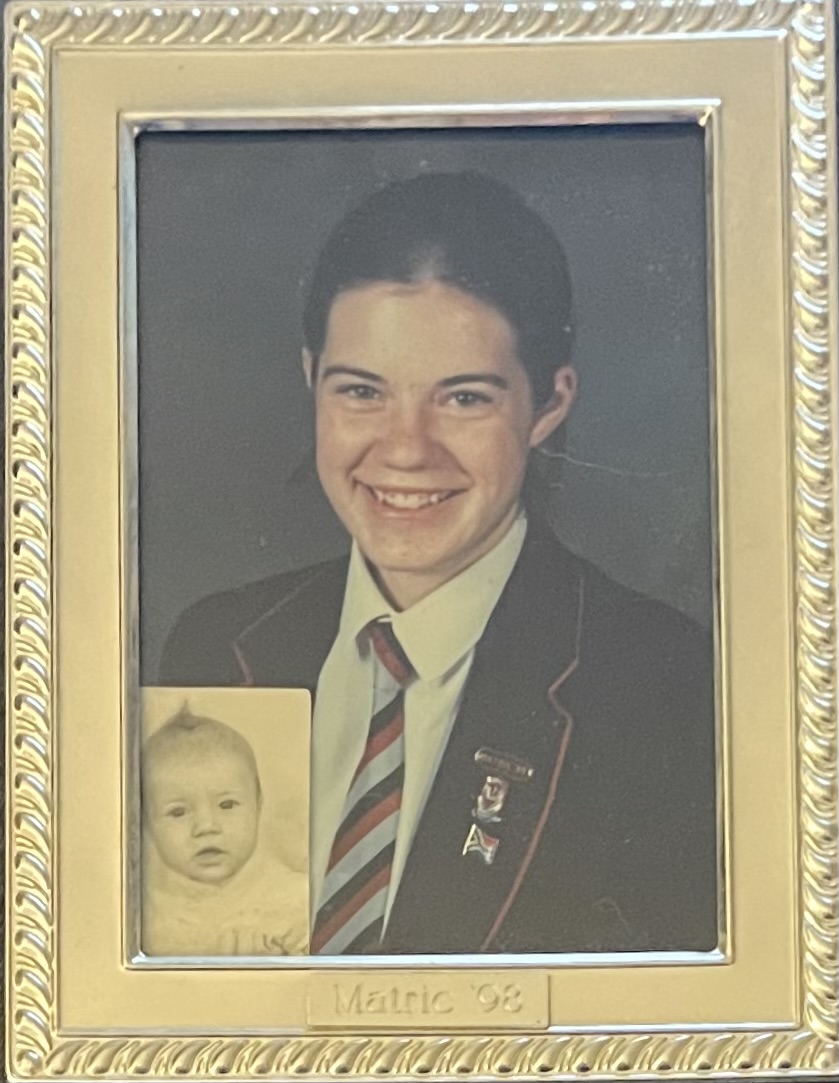 18 year old Jennifer in a school blazer for he Matric school photo, with a passport photo of her as a baby